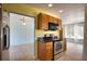 A kitchen featuring stainless steel appliances, black countertops, and wood cabinetry at 221 Laurel E Rd, Nokomis, FL 34275