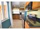 Bright kitchen featuring stainless steel appliances, granite countertops, and tile flooring at 221 Laurel E Rd, Nokomis, FL 34275