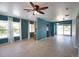 Spacious living room filled with natural light, featuring tile floors, a ceiling fan and backyard views at 221 Laurel E Rd, Nokomis, FL 34275