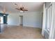 Bright living room with tile flooring, a ceiling fan, and neutral paint, creating a welcoming space at 221 Laurel E Rd, Nokomis, FL 34275