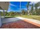 Outdoor patio area featuring both brick and concrete finishes, overlooking a tranquil waterfront at 221 Laurel E Rd, Nokomis, FL 34275