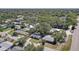 Neighborhood aerial view of a single-story home, concrete driveway, mature trees, and landscaping at 2412 Grove St, Sarasota, FL 34239