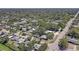 Wide aerial view of a community, showing many houses, streets, and lush vegetation at 2412 Grove St, Sarasota, FL 34239