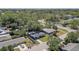 Neighborhood aerial view of a single-story home, concrete driveway, mature trees, and landscaping at 2412 Grove St, Sarasota, FL 34239
