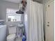 Functional bathroom space featuring a toilet, sink, and shower with a curtain at 2412 Grove St, Sarasota, FL 34239