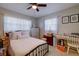 Cozy bedroom featuring a bed, dresser, and ample natural light from the windows at 2412 Grove St, Sarasota, FL 34239