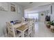 Bright dining room with a neutral color palette and views into the living area at 2412 Grove St, Sarasota, FL 34239