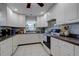 White kitchen features white appliances, window and neutral countertops at 2412 Grove St, Sarasota, FL 34239