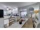 Bright kitchen and dining area with white cabinets, stainless appliances, and views into the adjacent living room at 2412 Grove St, Sarasota, FL 34239