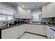 Kitchen area featuring ample white cabinetry, granite countertops, and a view from the window at 2412 Grove St, Sarasota, FL 34239