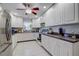 Bright kitchen boasting white cabinets, modern appliances, and tile flooring, offering a clean, functional space at 2412 Grove St, Sarasota, FL 34239