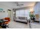 Cozy living room with tile floors, neutral paint, and oversized window letting in plenty of natural light at 2412 Grove St, Sarasota, FL 34239