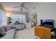 Bright sunroom with plants, tile floors, and a gray sofa, with large windows providing ample natural light at 2412 Grove St, Sarasota, FL 34239