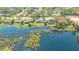 Breathtaking aerial view of a waterfront property with lush landscaping and serene lake views at 3033 Grafton St, Sarasota, FL 34231