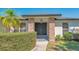 Close up of front entrance with black double doors, stone columns, and manicured landscaping at 3033 Grafton St, Sarasota, FL 34231