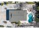 Aerial view of home featuring a roof, pool and spa, patio furniture, and an exterior entirely enveloped in rock at 313 Magnolia Ave, Anna Maria, FL 34216
