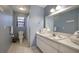 Clean bathroom with a large mirror, ample counter space, and tiled floors for easy maintenance at 313 Magnolia Ave, Anna Maria, FL 34216
