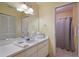 Well-lit bathroom with ample counter space and a shower at 313 Magnolia Ave, Anna Maria, FL 34216