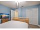 Comfortable bedroom with blue walls, a wooden bed frame, and plenty of closet space at 313 Magnolia Ave, Anna Maria, FL 34216