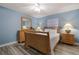 Relaxing bedroom with light blue walls, natural light, and wooden furniture at 313 Magnolia Ave, Anna Maria, FL 34216