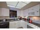 Functional kitchen with ample counter space, modern appliances, and efficient design, perfect for cooking and meal preparation at 313 Magnolia Ave, Anna Maria, FL 34216