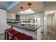 Bright kitchen with granite countertops, an island, and modern appliances for a chef-like experience at 313 Magnolia Ave, Anna Maria, FL 34216