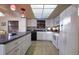 Bright kitchen with white cabinets, stainless steel appliances, and tiled floor for easy cleanup at 313 Magnolia Ave, Anna Maria, FL 34216