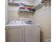 Laundry room with washer, dryer and storage shelves at 313 Magnolia Ave, Anna Maria, FL 34216