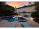 Inviting pool and spa area with lush landscaping and ample seating for relaxation and entertaining friends and Gathering at 313 Magnolia Ave, Anna Maria, FL 34216