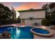 Inviting pool and spa area with lush landscaping and ample seating for relaxation and entertaining friends and Gathering at 313 Magnolia Ave, Anna Maria, FL 34216