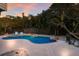 Beautiful pool with tropical landscaping and lounge chairs surrounded by a privacy fence at 313 Magnolia Ave, Anna Maria, FL 34216
