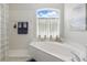 Bright and clean bathroom highlighting the soaking tub with natural light and tile accents at 3218 45Th E Way, Bradenton, FL 34203
