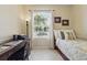 Bright bedroom with tile flooring, a comfortable bed, and a desk area for work or study at 3218 45Th E Way, Bradenton, FL 34203