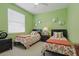 Charming twin bedroom with floral bedding and stylish décor makes the space more appealing at 3218 45Th E Way, Bradenton, FL 34203