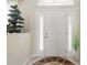 Inviting front entryway with a glass-paneled door, decorative sidelights, and neutral tile flooring at 3218 45Th E Way, Bradenton, FL 34203