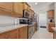 Well-equipped kitchen with stainless steel appliances, ample cabinet space, and a tiled floor at 3218 45Th E Way, Bradenton, FL 34203