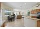 Open kitchen and dining area that flows into a living room with natural light and modern appliances at 3218 45Th E Way, Bradenton, FL 34203