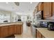 The bright kitchen overlooks the living room and features stainless appliances, tile flooring and wood cabinetry at 3218 45Th E Way, Bradenton, FL 34203