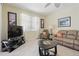 This living room features tile flooring, a television, and comfortable seating creating a warm and inviting space at 3218 45Th E Way, Bradenton, FL 34203