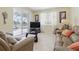 Cozy living room with tile floors, comfortable seating, and a sliding glass door to the outdoor area at 3218 45Th E Way, Bradenton, FL 34203