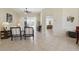 Tiled living room featuring comfortable seating, ceiling fan, and a view into additional living space at 3218 45Th E Way, Bradenton, FL 34203