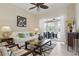 Bright living room with tiled floors, ceiling fan, and sliding glass doors leading to the outdoor patio at 3218 45Th E Way, Bradenton, FL 34203