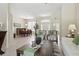 Open-concept living room with tiled floors, dining area, and large windows that bring in natural light at 3218 45Th E Way, Bradenton, FL 34203