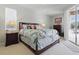 Well-lit main bedroom featuring a bed, dresser, and access to the outdoor area through a sliding glass door at 3218 45Th E Way, Bradenton, FL 34203