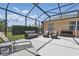 Screened patio with ample seating and a swing offers a comfortable outdoor living space at 3218 45Th E Way, Bradenton, FL 34203