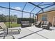 Screened-in patio area featuring tile flooring and comfortable outdoor seating for relaxing and entertaining at 3218 45Th E Way, Bradenton, FL 34203