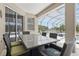 Covered patio offers comfortable seating and dining with serene lake views and nearby pool at 3218 45Th E Way, Bradenton, FL 34203