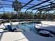 Screened-in pool with lounge seating and landscaping providing an ideal outdoor space at 3218 45Th E Way, Bradenton, FL 34203