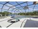 Large screened-in pool area with lush landscaping creates a private backyard retreat at 3218 45Th E Way, Bradenton, FL 34203
