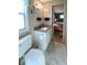 Bathroom showcasing a white vanity with granite countertop, toilet, and a view into the Primary bedroom at 3232 Ash Ter, Sarasota, FL 34237